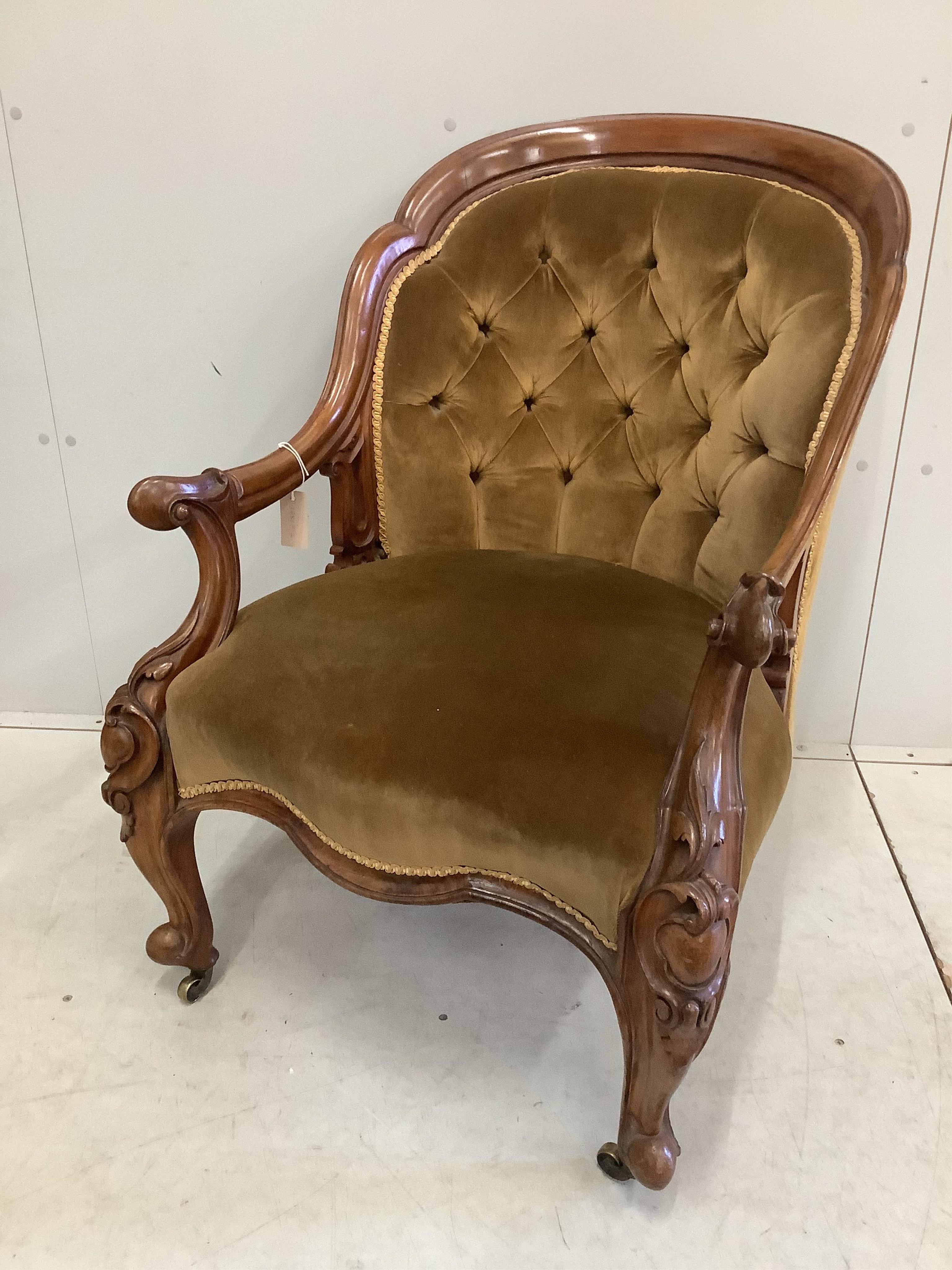 A late Victorian carved walnut spoonback upholstered open armchair, width 68cm, depth 64cm, height 92cm. Condition - good